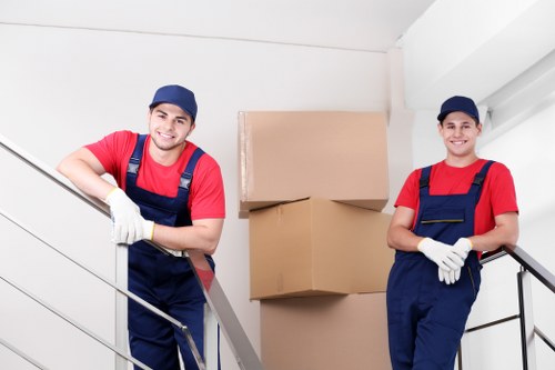 Same-day removals team loading boxes and furniture in Kensington