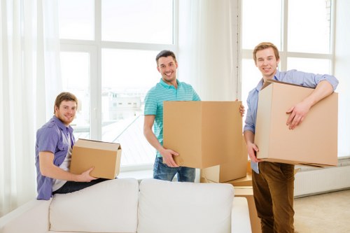 Professional movers packing furniture for urgent Kensington relocation