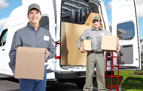 Professional team collecting old furniture in Kensington
