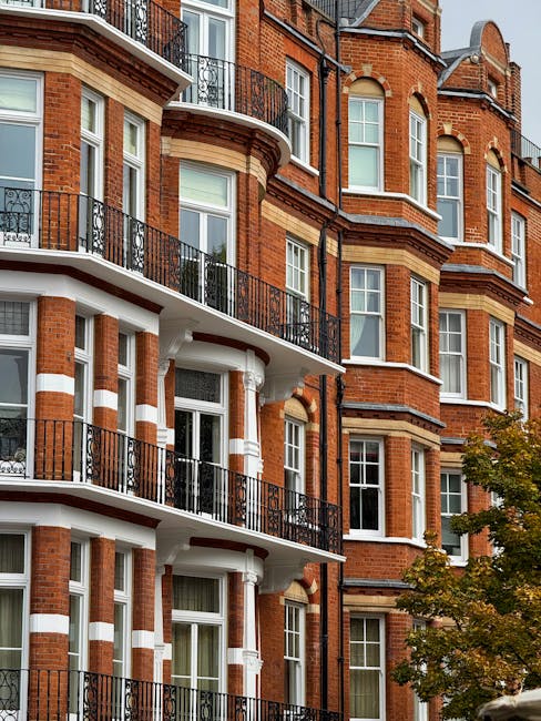 A rectangular street sign affixed to a red brick wall displaying the words 'Welcome to South Kensington' in black lettering, with 'SW7' in red at the bottom right corner and 'South Kensington' emphasi